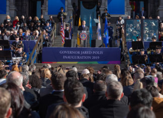 ‘Work Toward Something Great, Not Just When It Is Easy’ Governor Jared Polis Speaking in front of a large crowd of people
