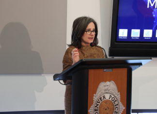 LEAD Program Aims to Stop ‘Revolving Door’ for Minor Offenders A lady in a brown dress standing behind a podium speaking