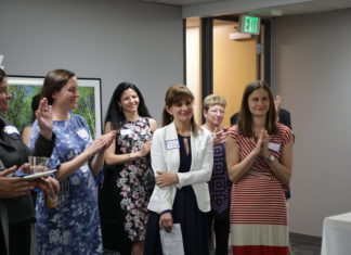 Legal Entrepreneurs for Justice Launches Inaugural Class five women clapping around a woman being recognized for an accomplishment