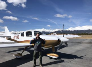 Attorney-Pilot Sets New World Record A man standing in front of a small white plane holding up a shirt