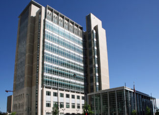 Death in SWAT Op Wasn’t Excessive Force, Jury Finds A tall building with many windows against a blue sky background