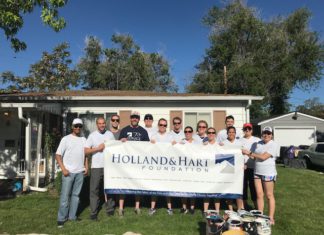 Summer Clerk Programs Offer Hands-on Learning A group of people holding up a large sign that says Holland and Hart