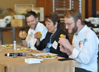 Lawyers Don Aprons for Networking and Charity Three people sitting at a table judging food and cocktails
