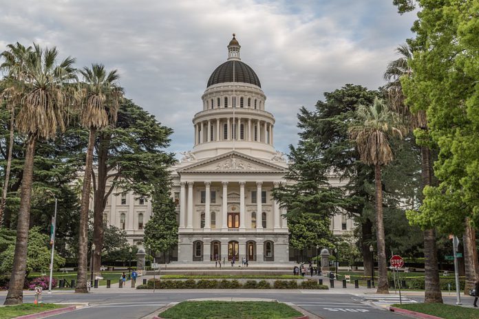California State Capitol lined with palm trees on the outside