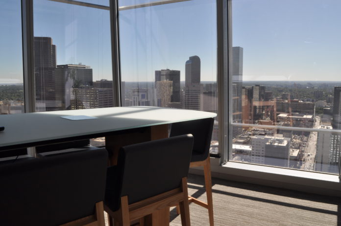 A desk on a the 22nd floor looking out on the Denver skyline A desk on a the 22nd floor looking out on the Denver skyline