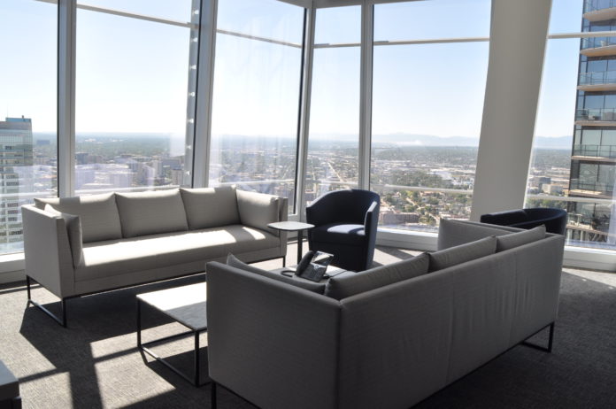 A conference room with couches that look out over Denver