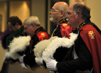Federal Jury Hits Knights of Columbus for $500,000 but Rejects Larger Claims Knights of Columbus in their uniforms bowing their heads