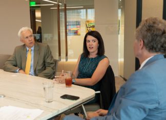 Developmental Drivers Three lawyers at a table talking in an animated way