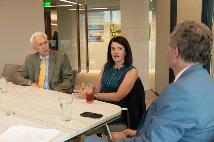 Three lawyers at a table talking in an animated way