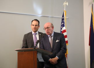 Relief Program Launches for Sex Abuse Victims of Colorado Catholic Priests Colorado Attorney General Weiser and attorney Kenneth Feinberg at a podium announcing a compensation program for people who suffered sexual abuse by Colorado Catholic priests as children.