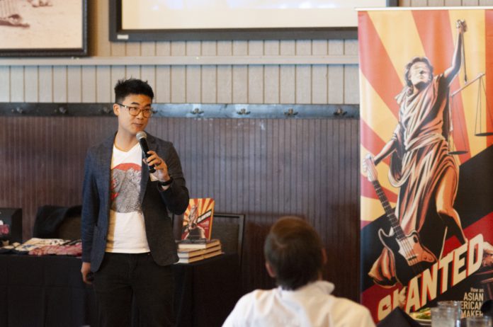 Denver activist Simon Tam speaking to a group of people at the Chop House Restaurant