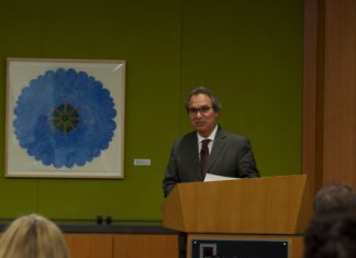 Pros and Cons of National Injunctions Man presenting behind a podium