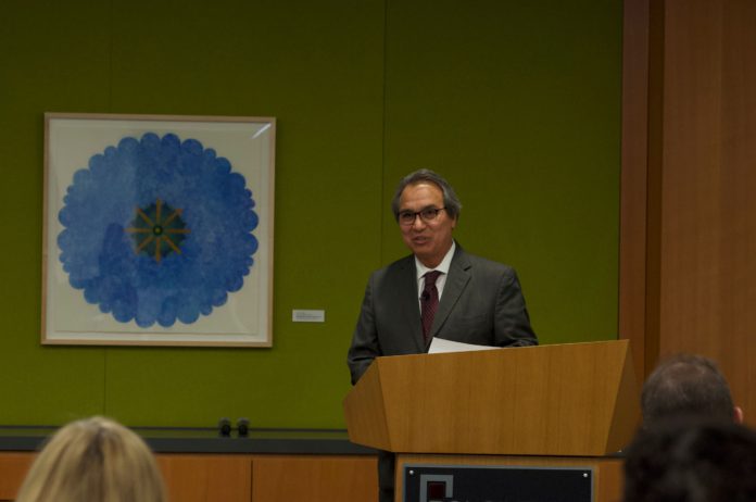 Man presenting behind a podium