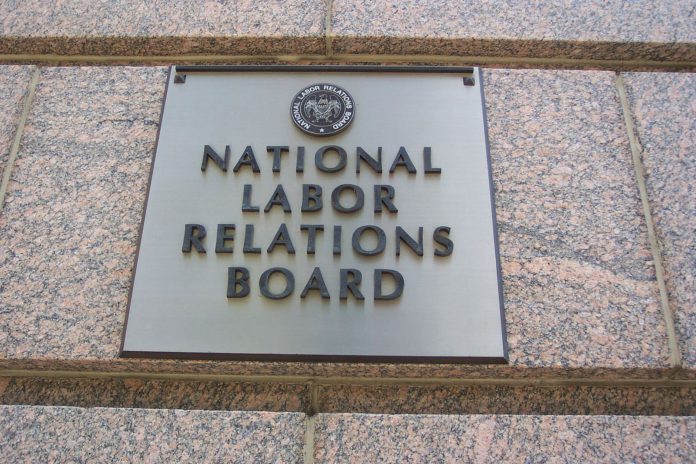 A metal plaque on a marble wall with the title National Labor Relations Board
