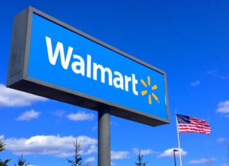 DOJ Launches Nationwide Opioid Lawsuit Against Walmart A large blue sign that reads Walmart in white bold letters
