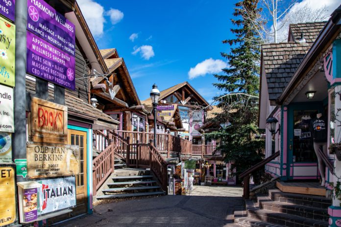 A mountain town that buildings are made out of logs and the street is paved with bricks