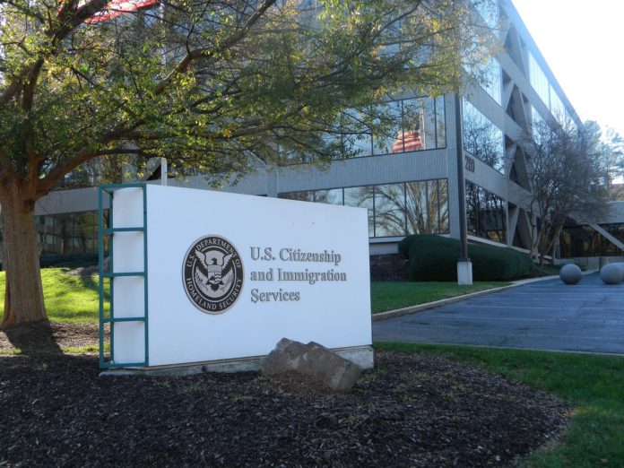 A big white sign that reads U.S Citizenship and Immigration Services A big white sign that reads U.S Citizenship and Immigration Services