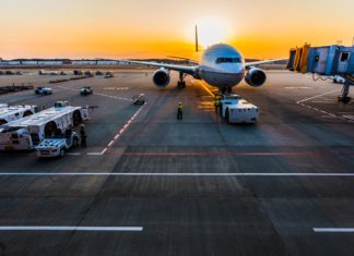 Colorado Supreme Court Clarifies Questions in Workers’ Comp Cases An airplane sits on the tarmac with luggage tugs nearby
