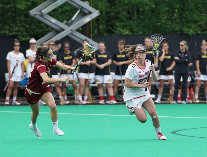 Two college athletes play in a lacrosse game