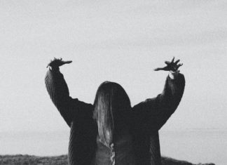 A Brief History of a Colorado Cult Silhouette of woman with arms raised