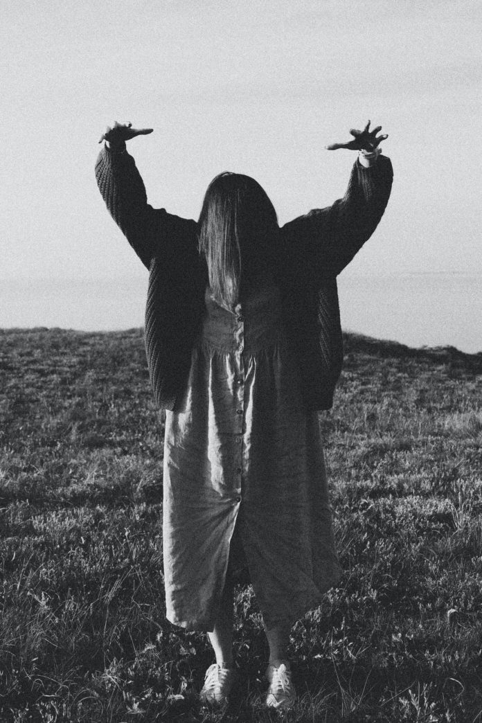 photo-1556611364-8abaeb89106c Silhouette of woman with arms raised