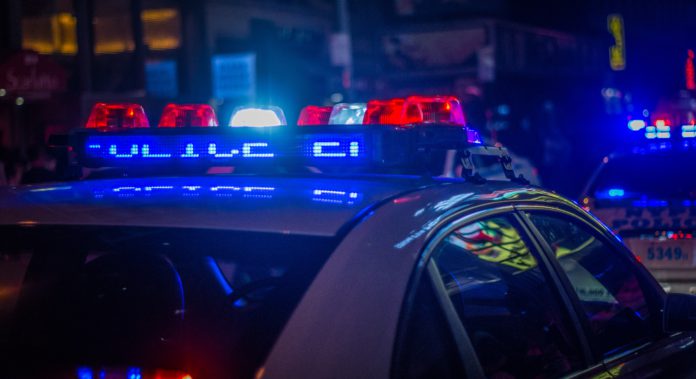 michael-fortsch-y5LaV9IEC_g-unsplash A police car with lights on