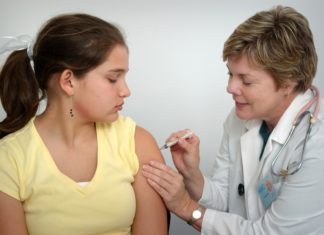 COVID Vaccines Pose New Challenges for Parents, Attorneys and Judges Girl getting a vaccine from a health professional