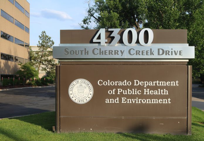 A sign for the Colorado Department of Public Health and Environment building.