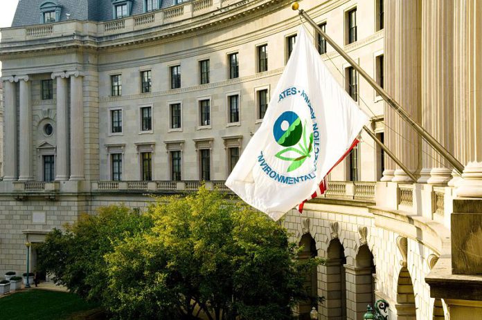 An EPA flag waves outside the EPA building.