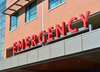 OSHA Emergency Standard in Effect for Health Care Employers, Everyone Else Gets Guidance An emergency room entrance.