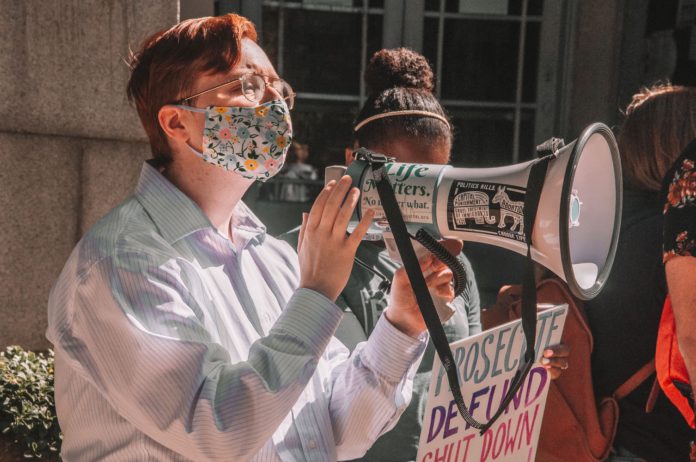 Pro-life protestors use a megaphone.