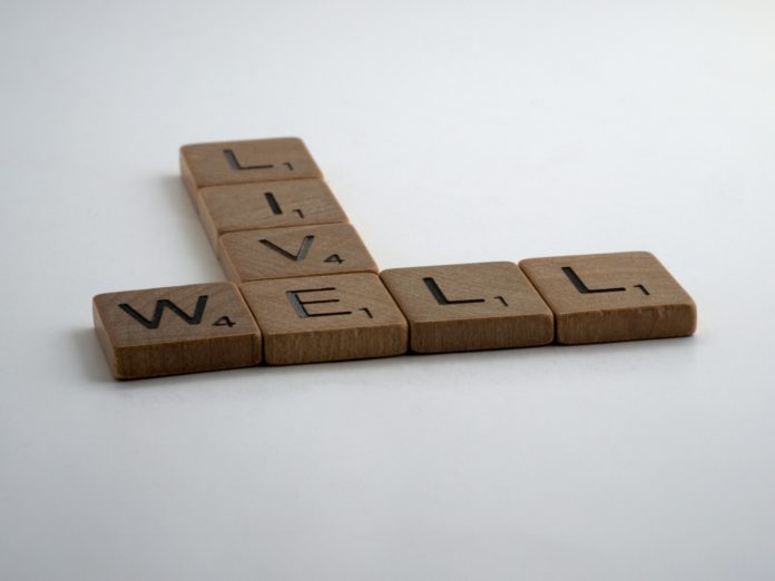 Scrabble tiles spell the words live well Scrabble tiles spell the words live well