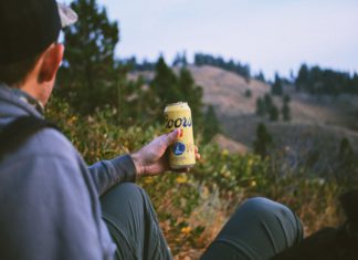 Adolph Coors’ Failed Kidnapping That Led to Murder A hiker looks down at a Coors beer can.