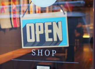 Small Business Legal Assistance Program Offers Permanent Pro Bono Services in Colorado Open sign hanging on glass door