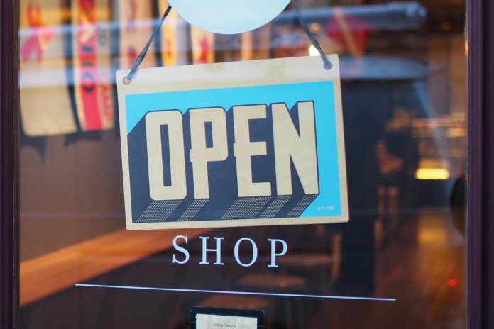 Open sign hanging on glass door Open sign hanging on glass door