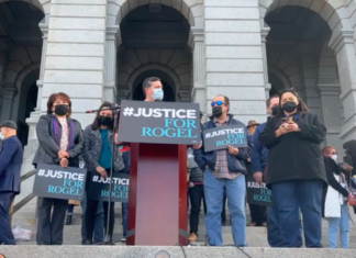 Lawmakers Call for Sentencing Reform at Rally for Rogel Aguilera-Mederos A man speaks at pedestal with people behind him at a rally on the Colorado State Capitol steps .