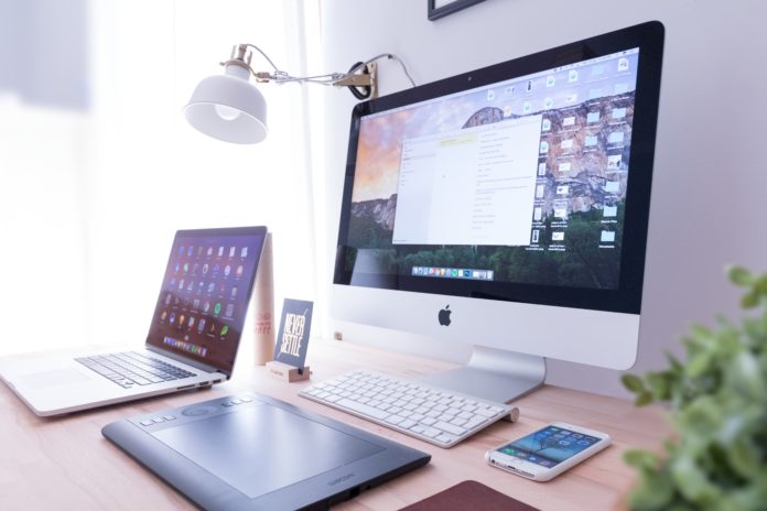 Desktop computer and laptop on desk