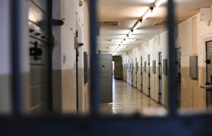 Prison hallway looking through bars
