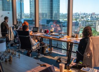 Legal Organizations Can Combat Industry Burn Out, Turnover with an ‘Inclusify’ Approach People sit at desks in an office