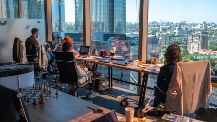 People sit at desks in an office