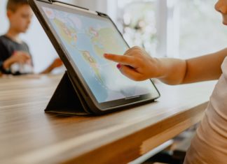 EEOC Updates Guidance on Pandemic-Related Discrimination Against Caregivers Child using tablet for remote learning