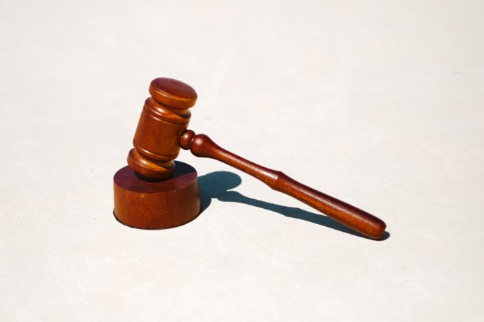 A wooden gavel on a blank white background