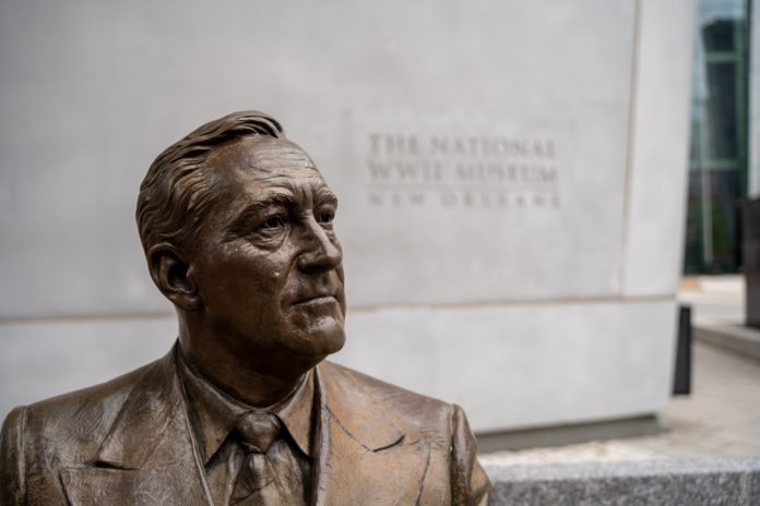 A statue of FDR sitting on a bench outside of the WWII museum.