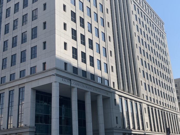 The Ralph Carr Judicial Center. A tall gray building with column at the bottom.