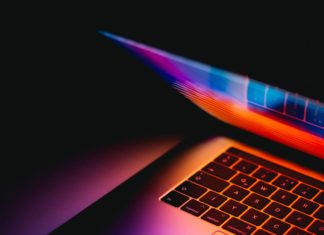 Colorado AG Gives Insight Into Upcoming Privacy Act A laptop is partially opened emitting a pink, blue and purple glow.