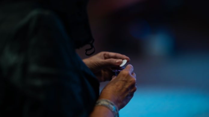 a woman holds a communion wafer.