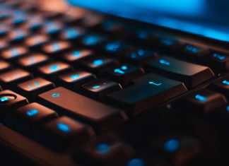 Colorado Attorneys Weigh in on Upcoming Colorado Privacy Act A closeup of a black keyboard with the keys lit up blue.