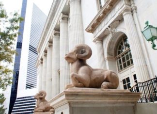 Jerome Holmes Replaces Timothy Tymkovich as 10th Circuit Chief Judge The 10th Circuit Court of Appeals courthouse. Two white stone big horned sheep sit on pillars in front of a white stone building with long pillars.