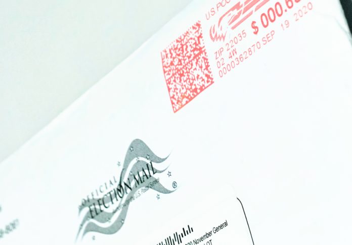 An envelope with a black and white logo reading official election mail
