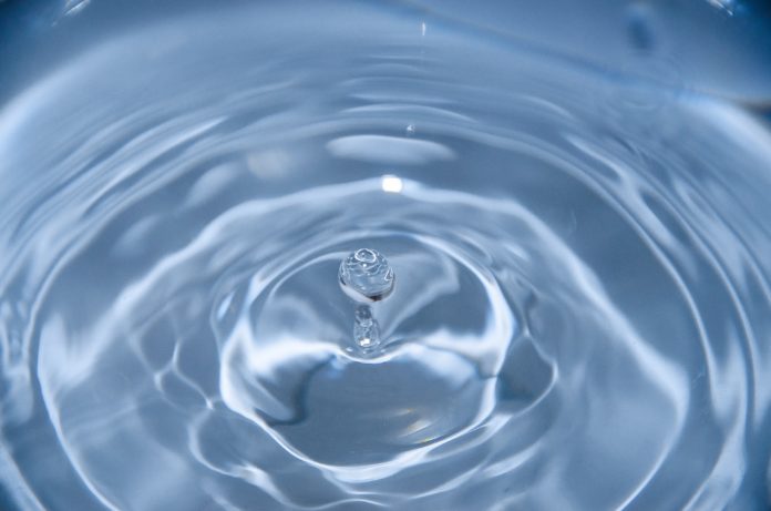 A droplet of water causes waves to move outward.